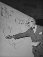 swiss-architect-le-corbusier-standing-on-stage-with-notes-in-his-hand-and-drawing-on-sketch-pad.jpg